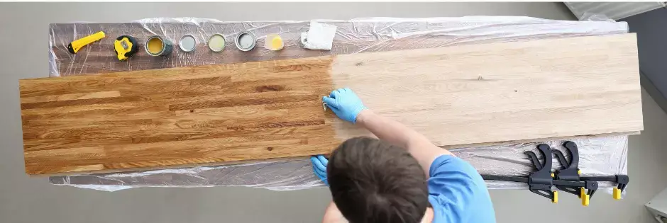 Technician in gloves performing surface restoration services